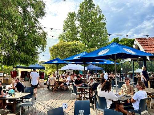 The Caves House Beer Deck with people enjoying their afternoons at the pub