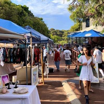 Girl in white dress walking around the twilight markets